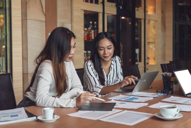 Group beautiful Asian businesswoman meeting an analytical using graph laptop concept accounting wor
